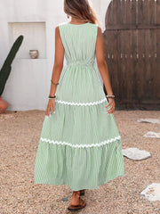 Light green striped maxi dress with white lace trim and smocked waist