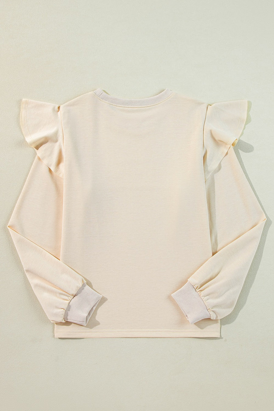 Cream ruffled shoulder sweatshirt with ribbed cuffs and crew neck.