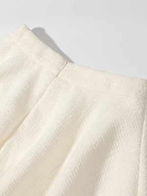 Textured cream button-down top with a visible zipper detail