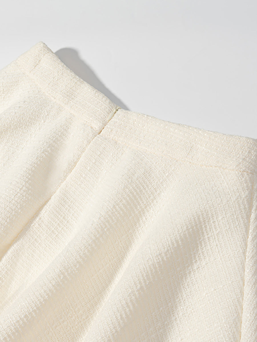Textured cream button-down top with a visible zipper detail