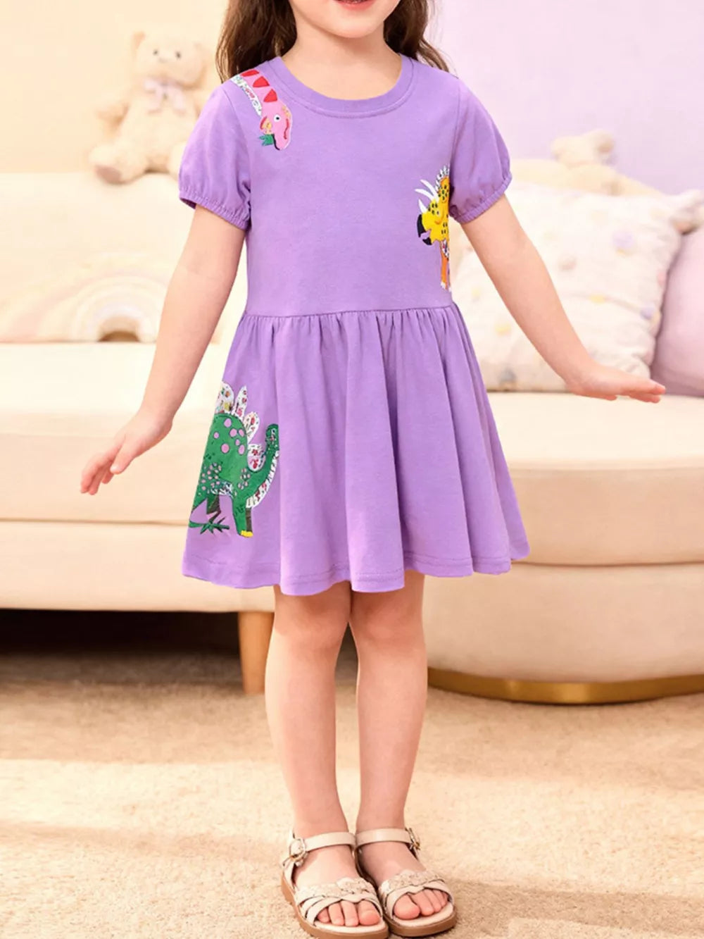 Purple cotton crew neck toddler dress with dinosaur print and flared skirt.