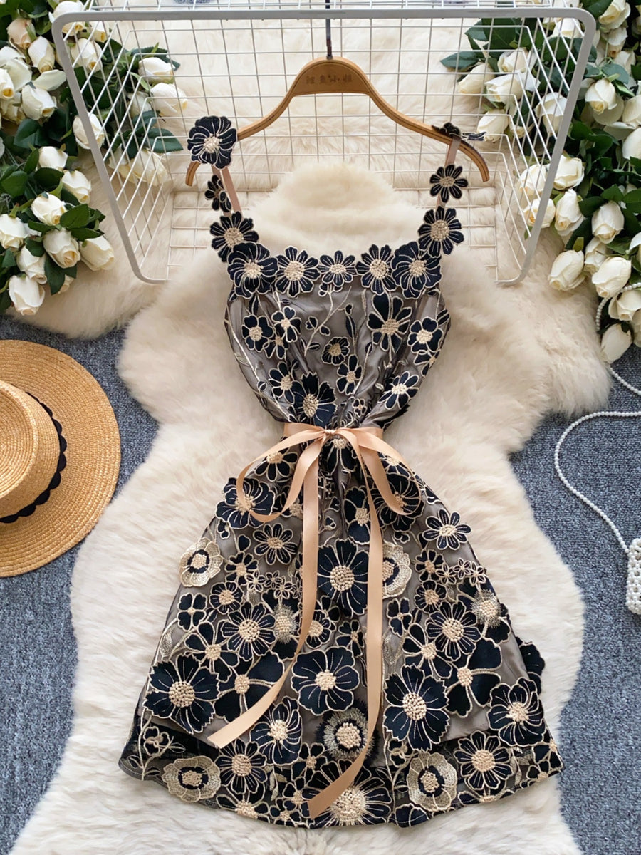 Black Gold embroidered floral mini dress with bow detail and ribbon tie.