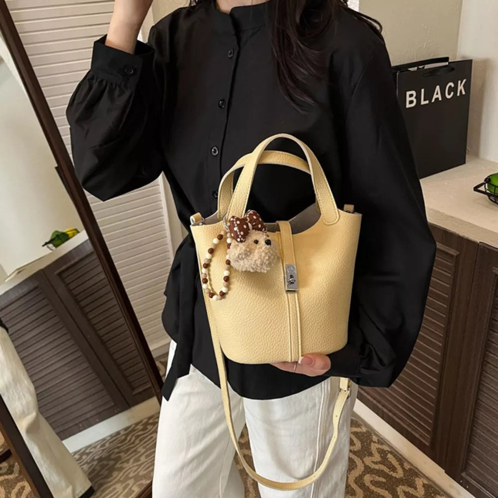 Leather Bucket Crossbody Bag in pale yellow with adjustable strap