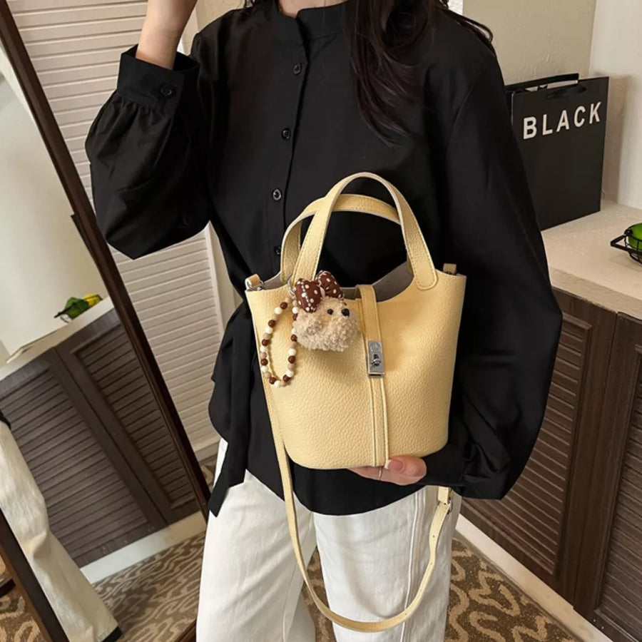 Leather Bucket Crossbody Bag in pale yellow with adjustable strap