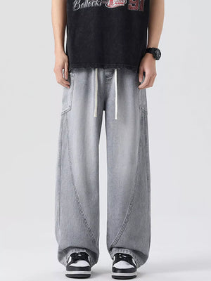 Oversized wide-leg jeans in smoky gray denim with a drawstring waist and vintage-inspired paneling.