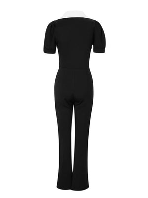 Black and white button-down jumpsuit with puff sleeves and wide legs.
