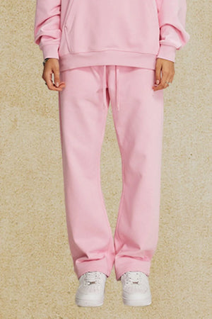 Blush pink relaxed fit lounge trousers with drawstring waist and cuffed ankles.