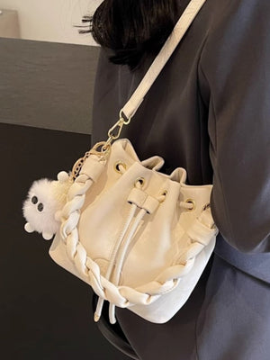 White bucket bag with chunky chain trim and fluffy charm
