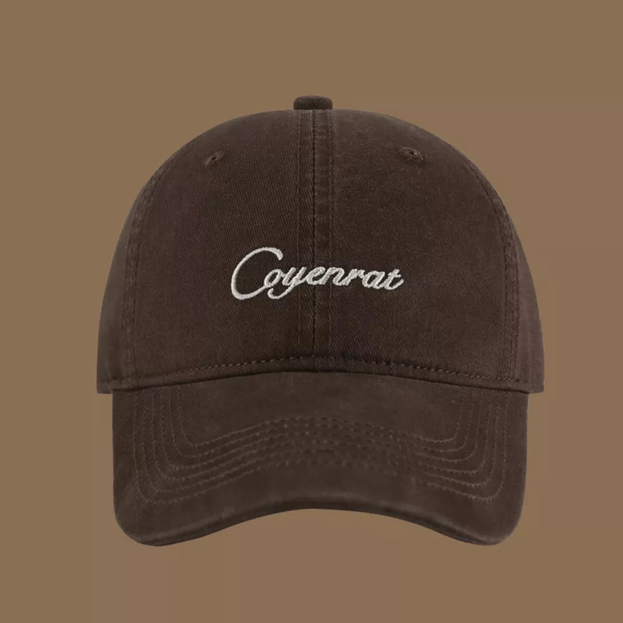 Brown baseball cap with white embroidered text