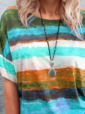 Casual t-shirt with brushstroke stripes in green, blue, orange, and white.