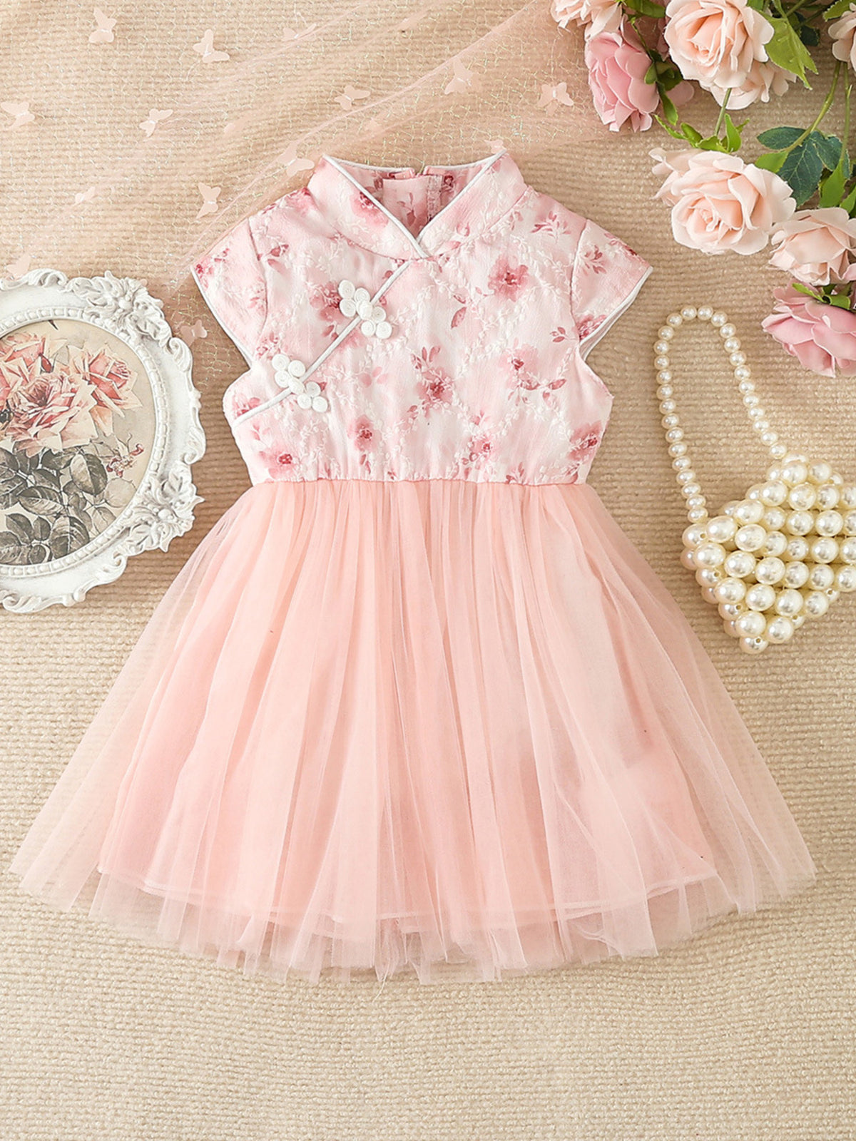 Pink floral cap sleeve baby dress with tulle skirt and mandarin collar.