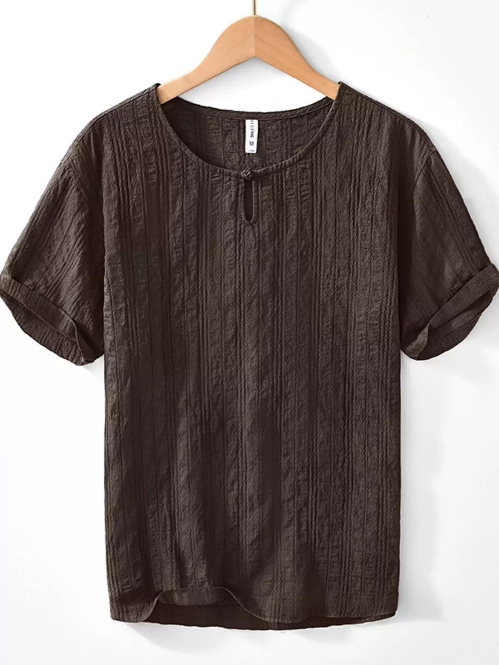 Textured short sleeve men's blouse in chocolate cotton with a button-neck detail.