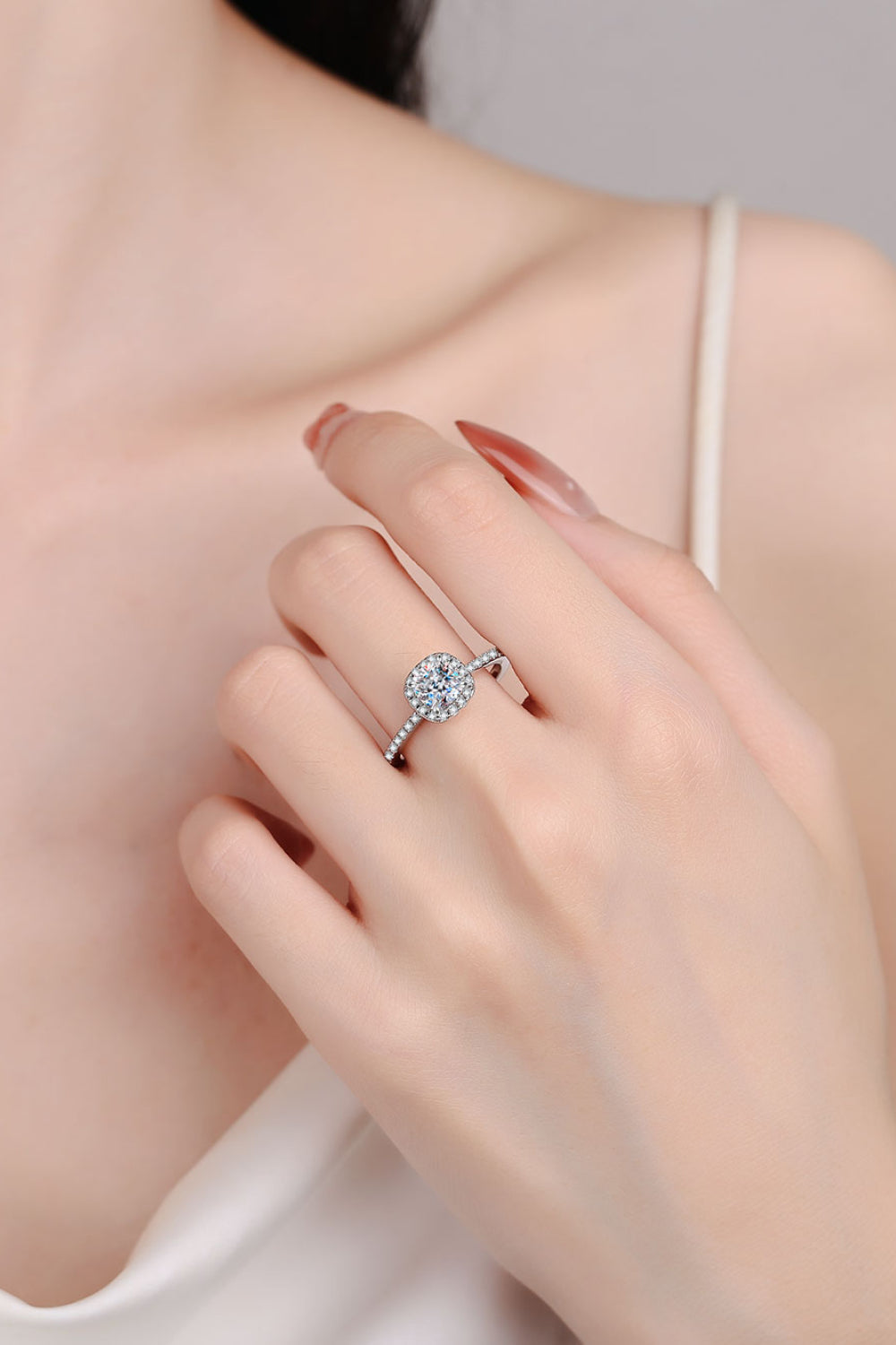 Silver pavé ring with cushion cut moissanite center stone and diamond band.