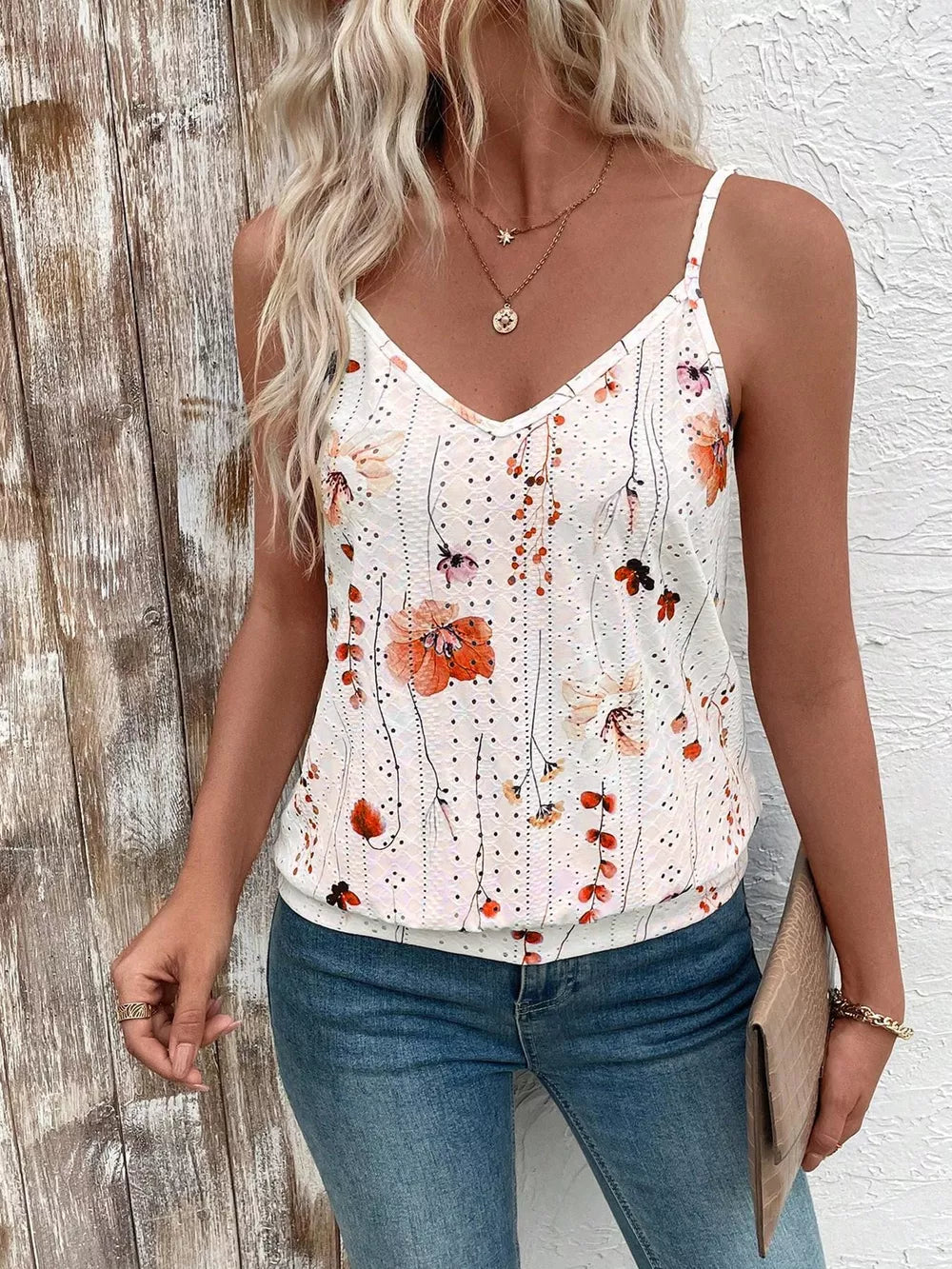 Floral V-neck camisole with eyelet detail and adjustable straps in white with orange floral print.
