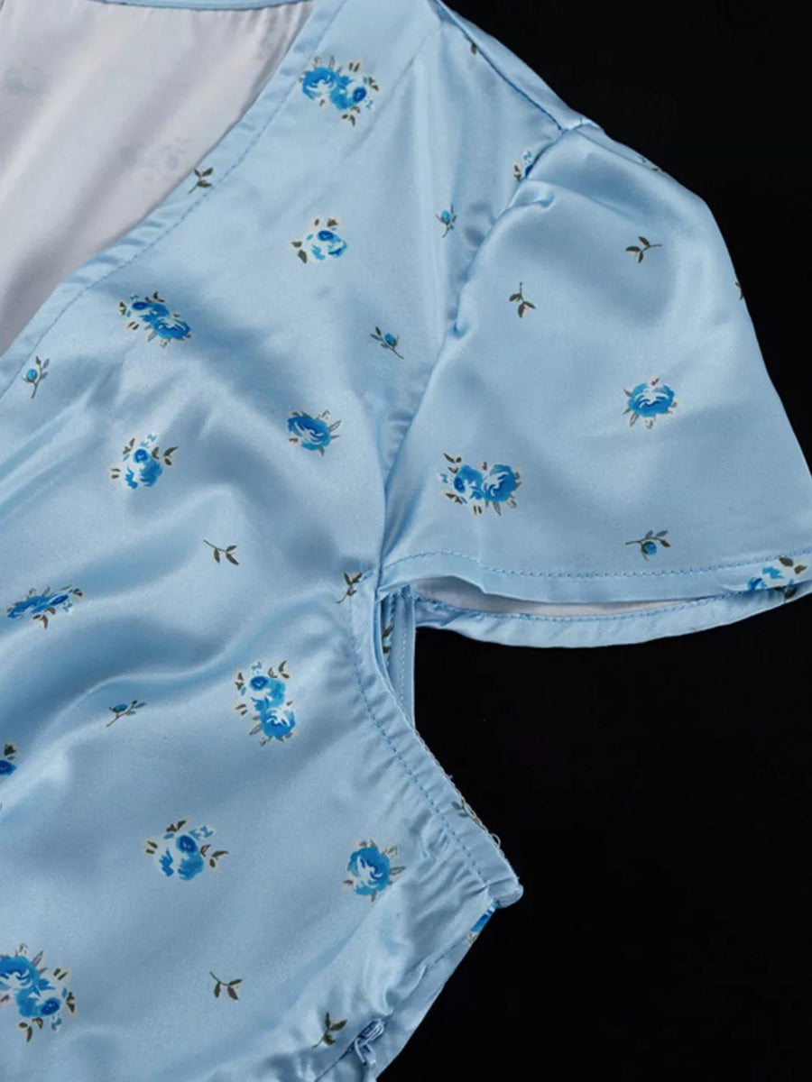 Blue floral print satin mini dress with V-neck and short sleeves.