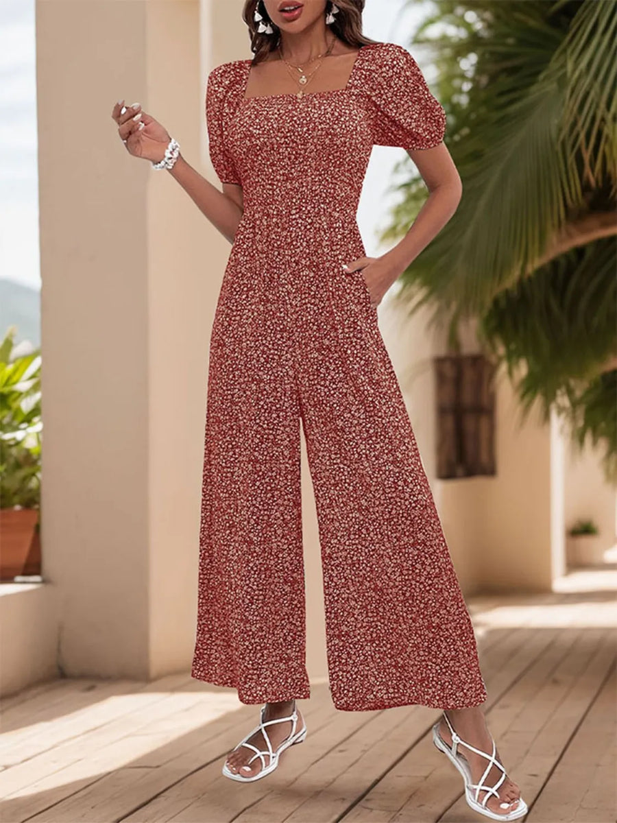 Rust floral print wide leg jumpsuit with smocked bodice and square neck.