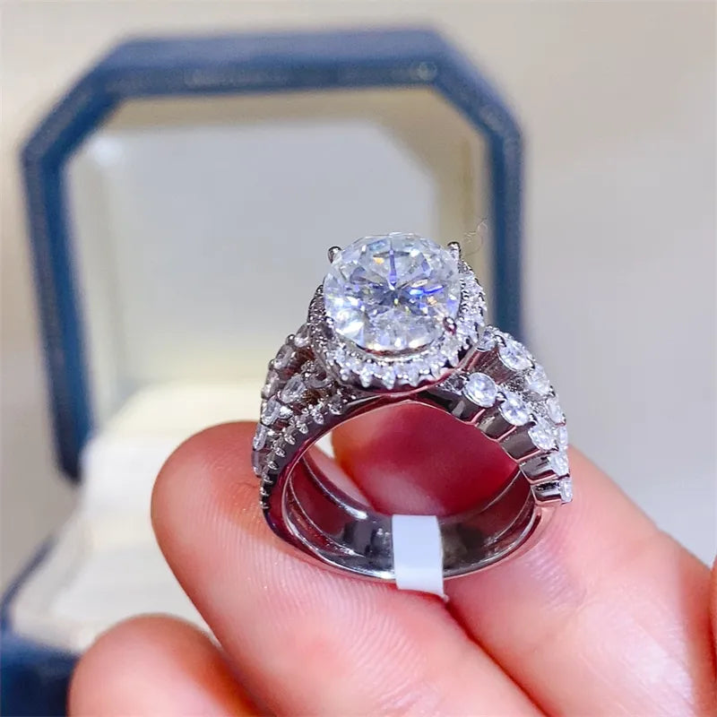 Silver triple band oval moissanite halo ring with pave accents.