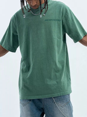 Green oversized graphic tee, 100% cotton, with subtle chest embroidery and a relaxed fit.