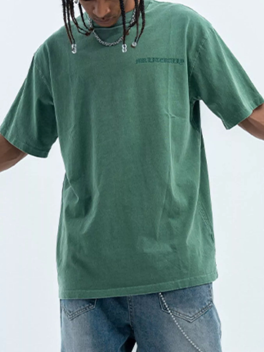 Green oversized graphic tee, 100% cotton, with subtle chest embroidery and a relaxed fit.