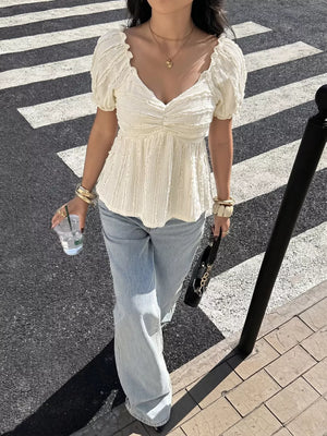 Charming textured white maternity t-shirt with puff sleeves and ruched neckline.