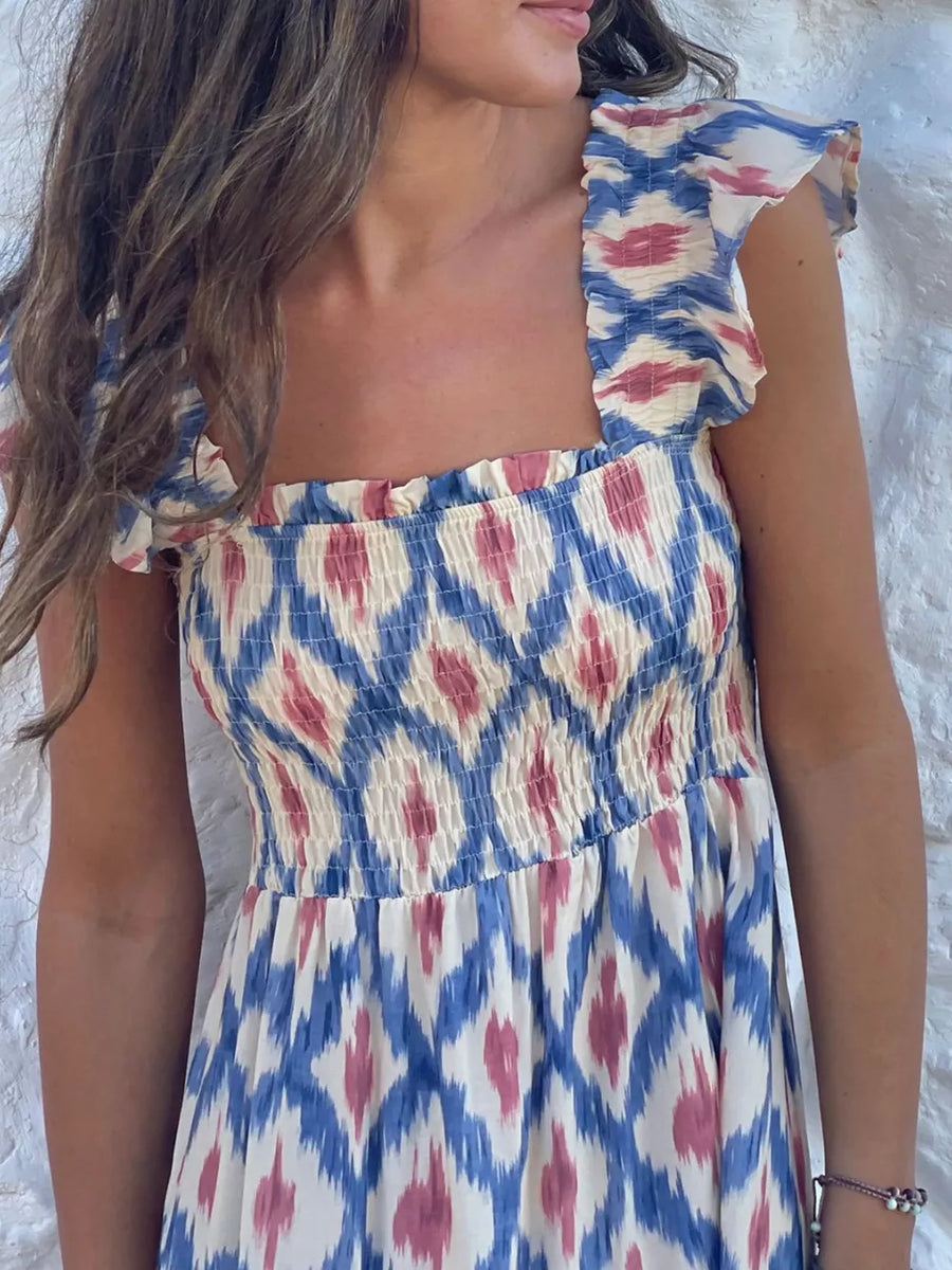 Smocked ruffle sleeve maxi dress with blue, pink, and cream ikat print.