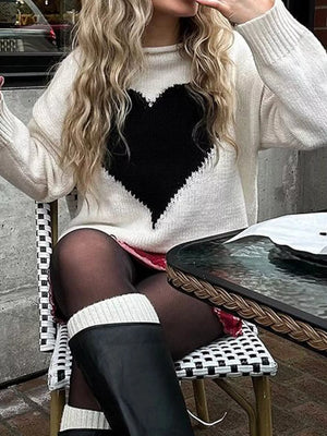 Gray/white acrylic blend sweater with a large black heart print and dropped shoulders.