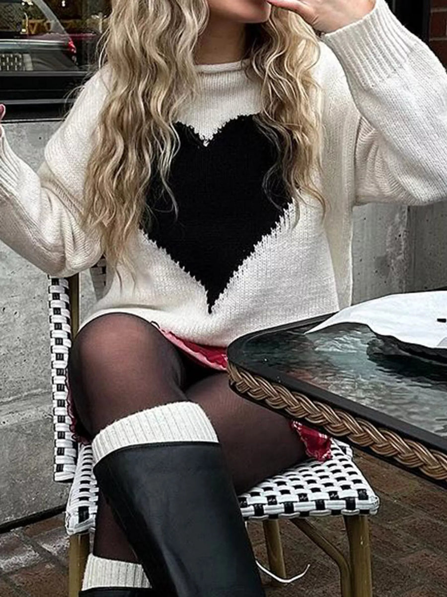 Gray/white acrylic blend sweater with a large black heart print and dropped shoulders.