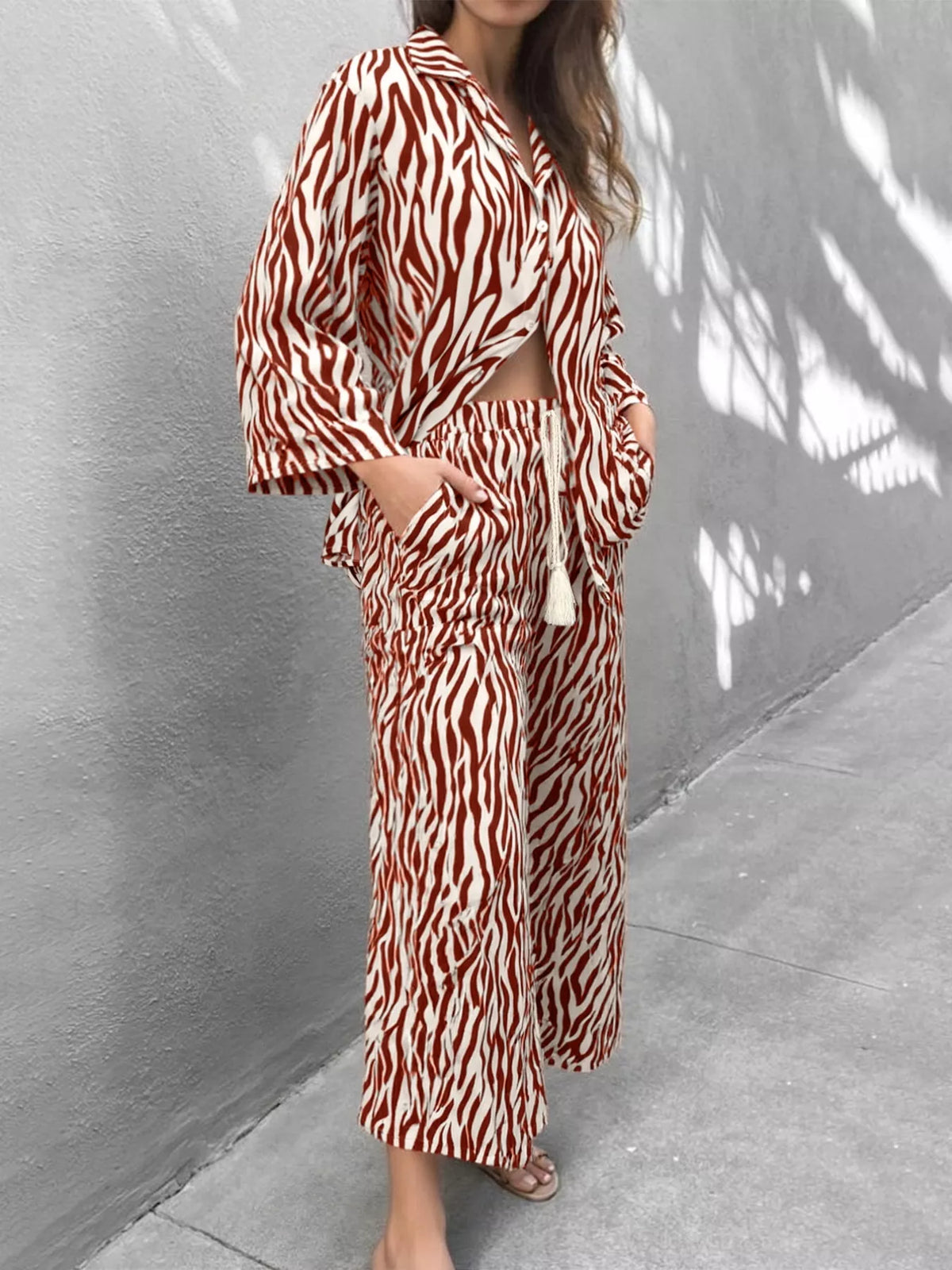 Brown zebra print relaxed two-piece loungewear set with wide leg pants and a cropped shirt.