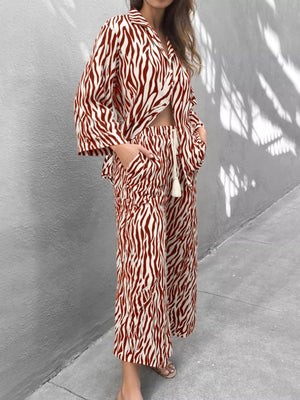 Brown zebra print relaxed two-piece loungewear set with wide leg pants and a cropped shirt.