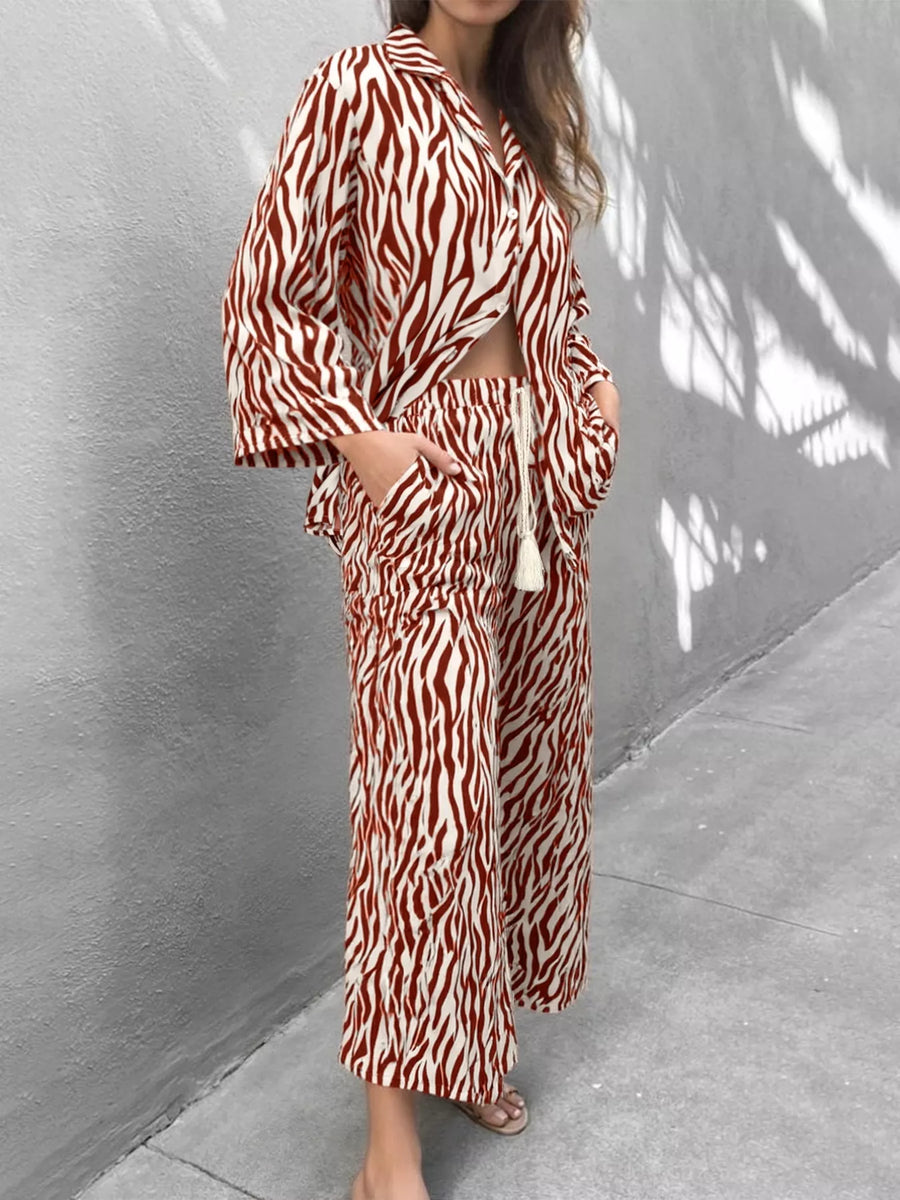 Brown zebra print relaxed two-piece loungewear set with wide leg pants and a cropped shirt.