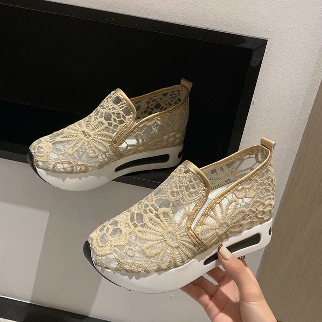 Khaki lace mesh slip-on flats with white soles and gold trim.