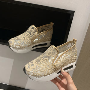 Khaki lace mesh slip-on flats with white soles and gold trim.