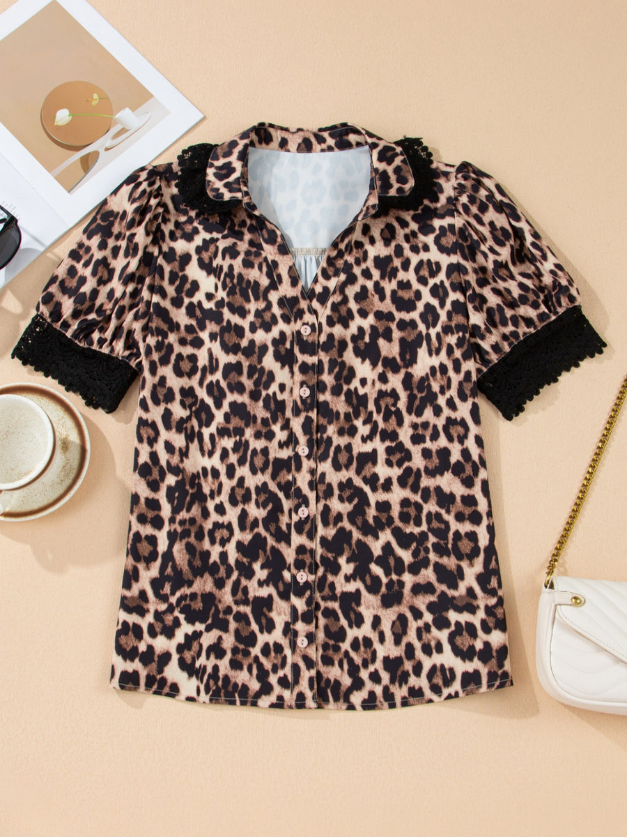 Women's leopard print short sleeve shirt with black lace trim collar and cuffs.