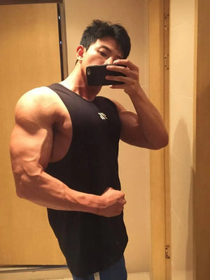 Black performance tank top with minimalist logo detail, sleeveless.