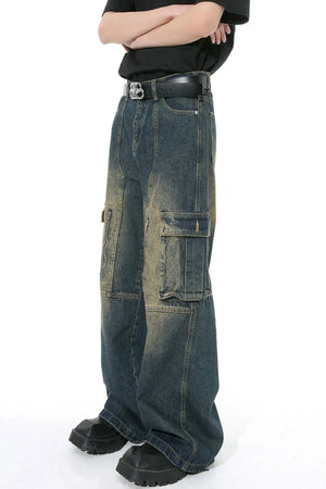 Dark wash distressed wide-leg cargo jeans with zippered pockets and a casual fit.