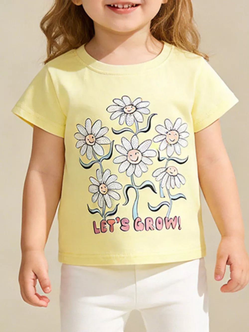 Yellow cotton t-shirt with cheerful daisy graphic and "Let's Grow!" text.