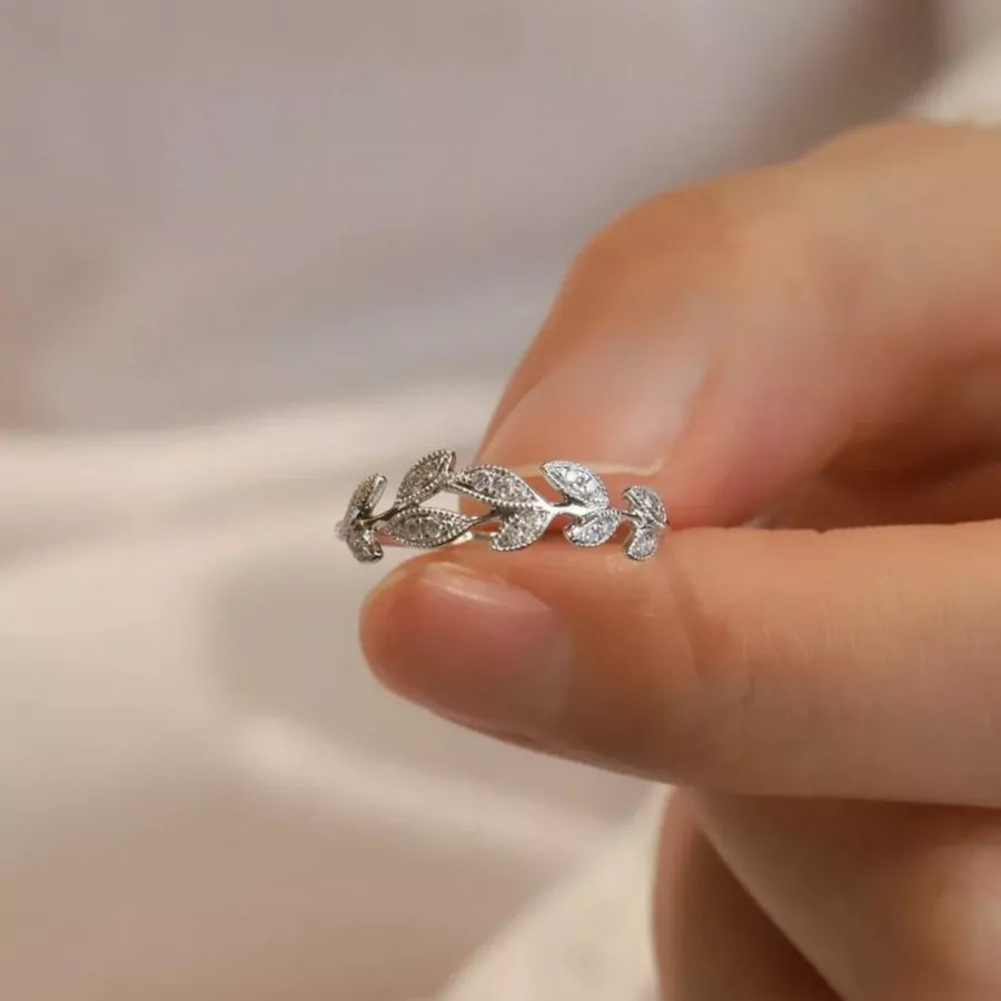 Delicate sterling silver ring with a leaf design and sparkling accents.