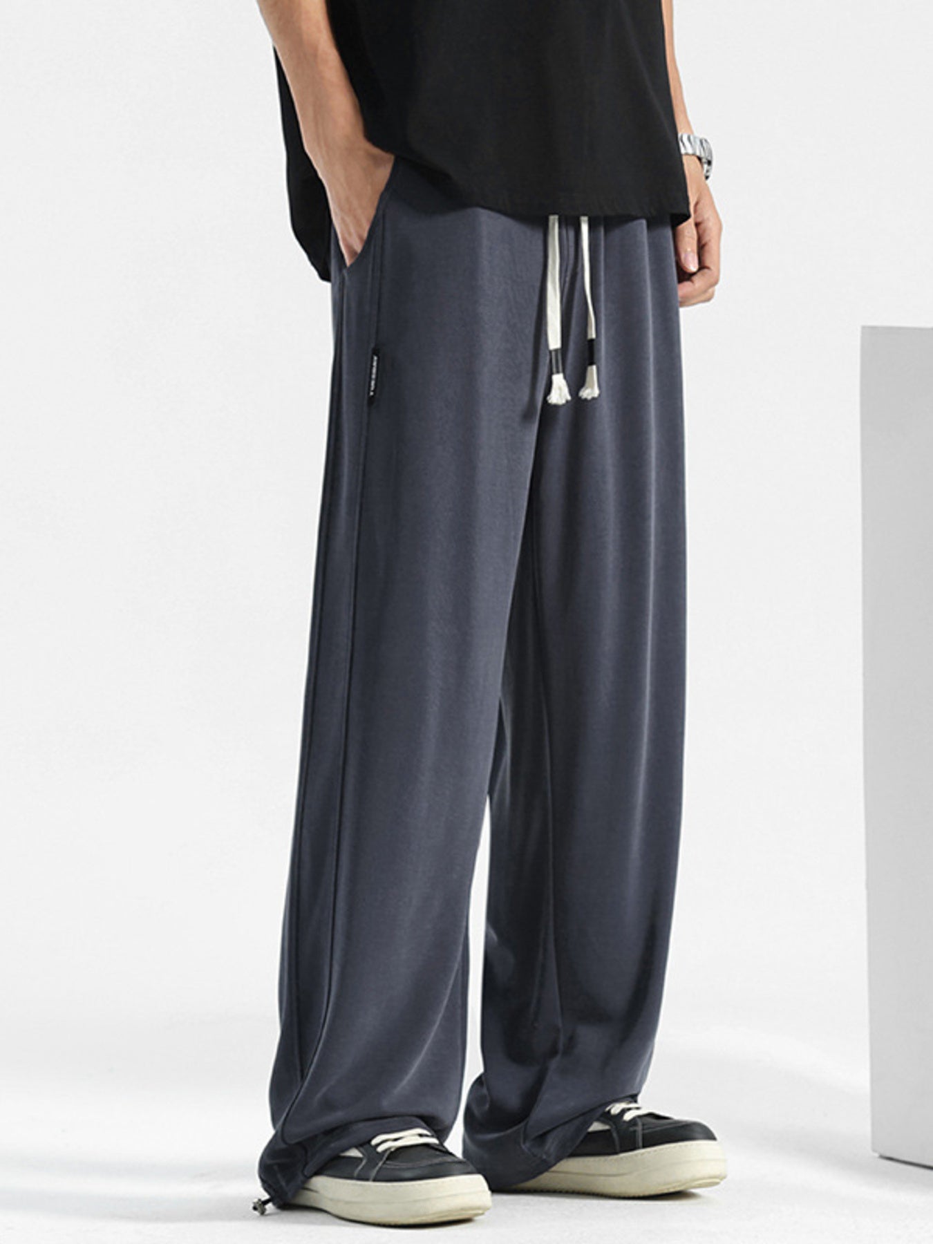 Men's navy blue loose fit sweatpants with drawstring waist and pockets.