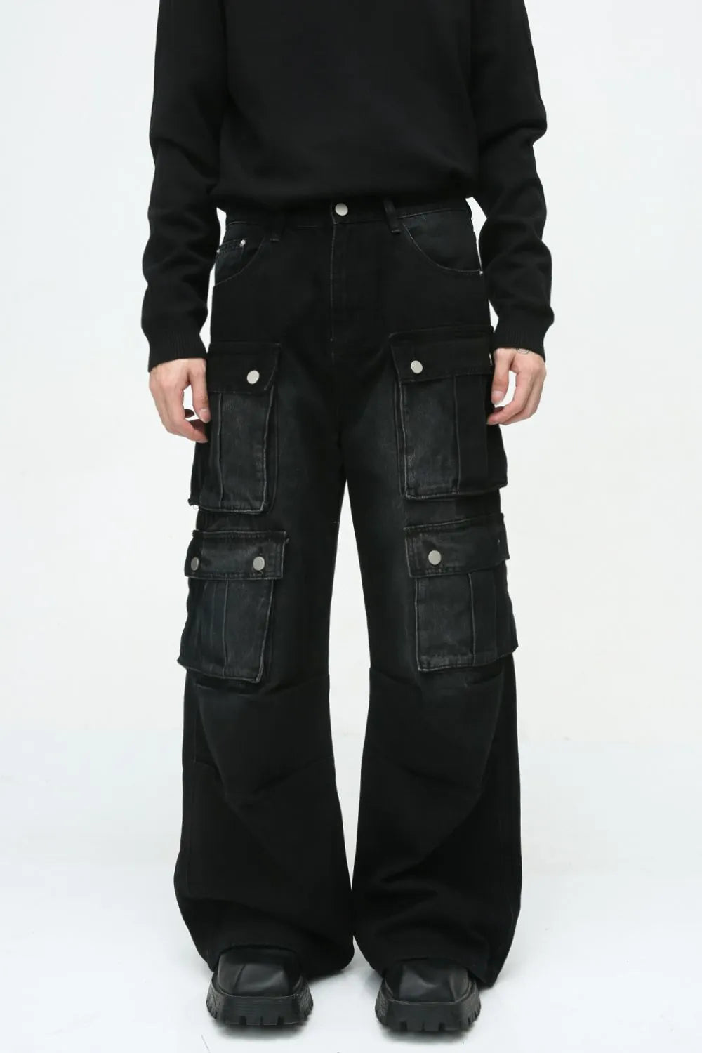 Dark denim wide-leg cargo pants with multiple utility pockets and silver button closures.