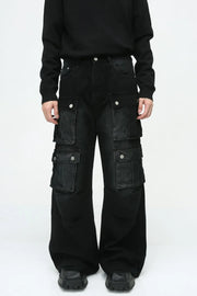 Dark denim wide-leg cargo pants with multiple utility pockets and silver button closures.