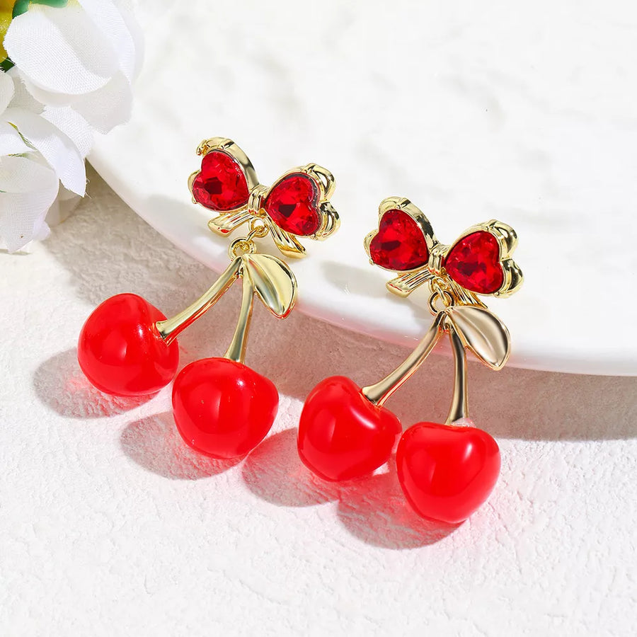 red earrings featuring drop design and novelty