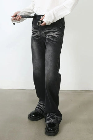 Distressed dark flare denim jeans with stitch detail and a black belt.