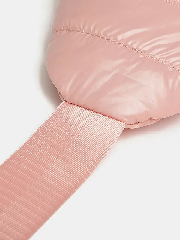 Glossy padded sling bag in pink with a textured strap detail.