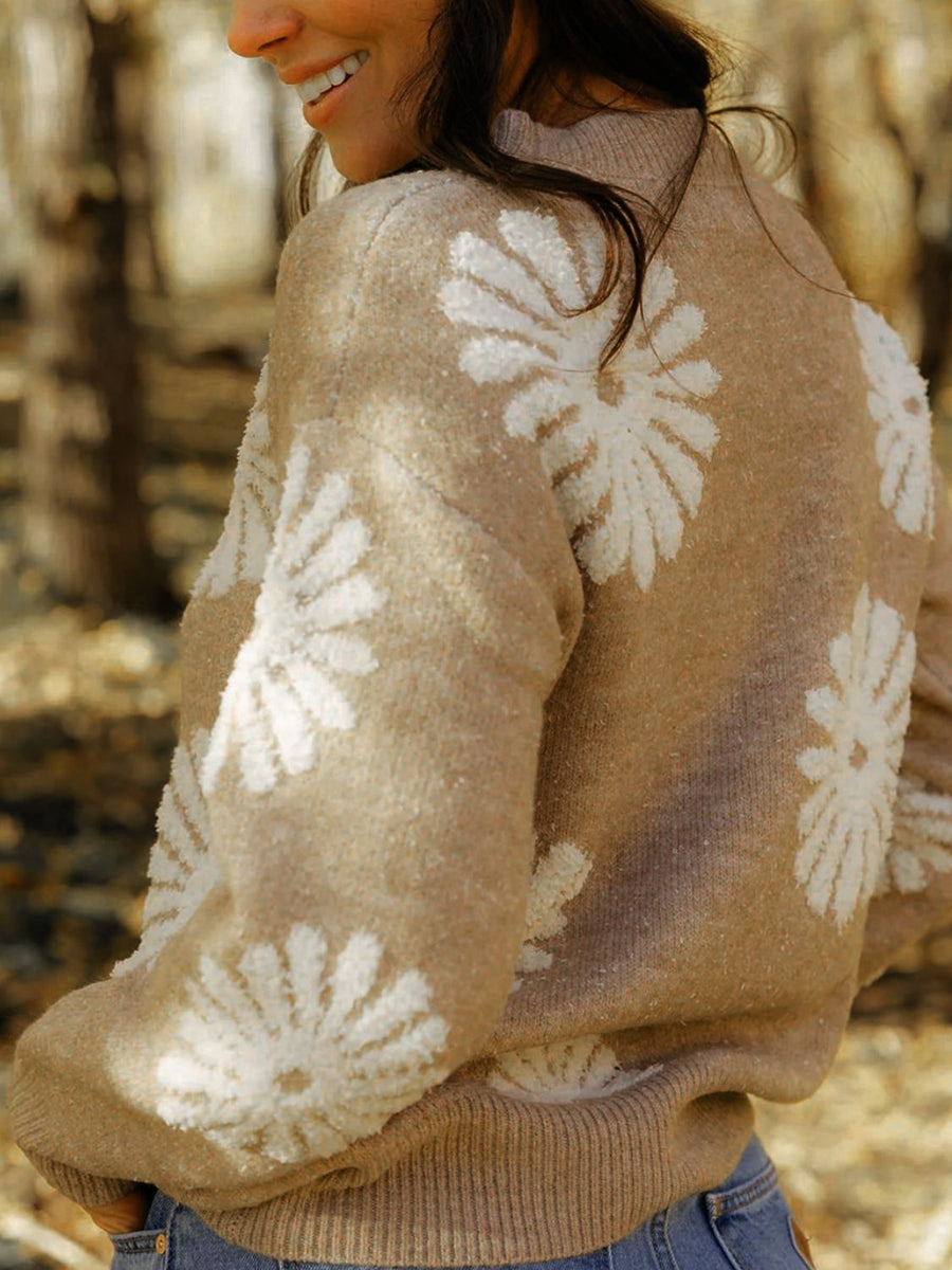 Tan knit sweater with textured floral motifs, crew neck, long sleeves, and ribbed cuffs and hem.