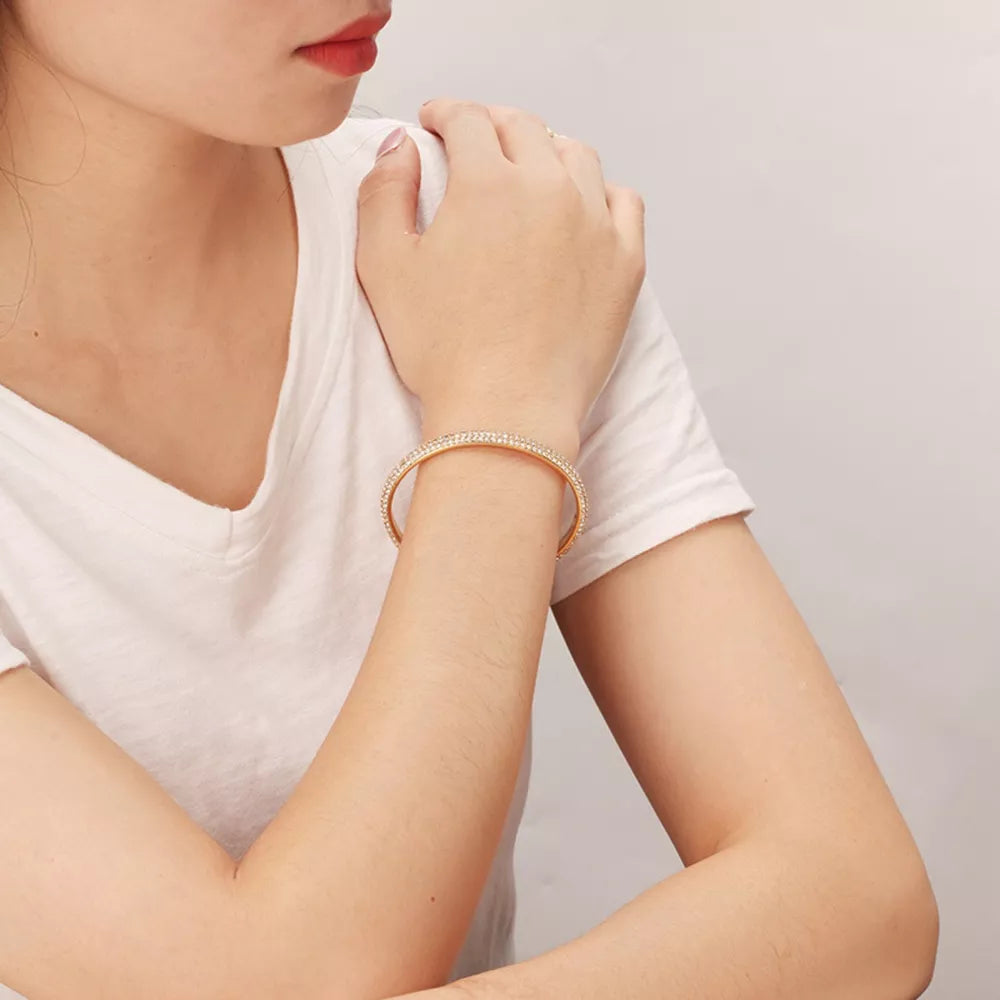 bracelet in gold featuring zircon embellishment and open cuff fit
