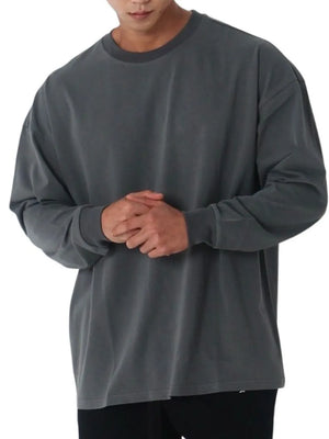 Oversized crewneck long sleeve tee in dark gray washed cotton with relaxed fit.