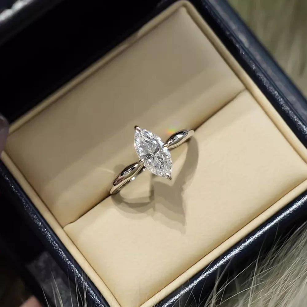 Marquise diamond engagement ring in a silver band with a twisted shank.