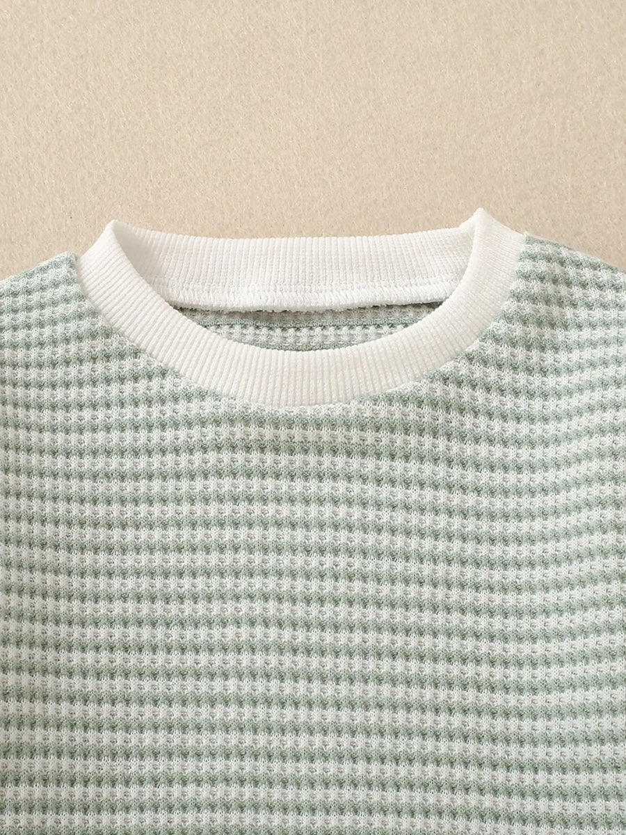 Baby knit set in light green waffle texture with white ribbed crew neck.