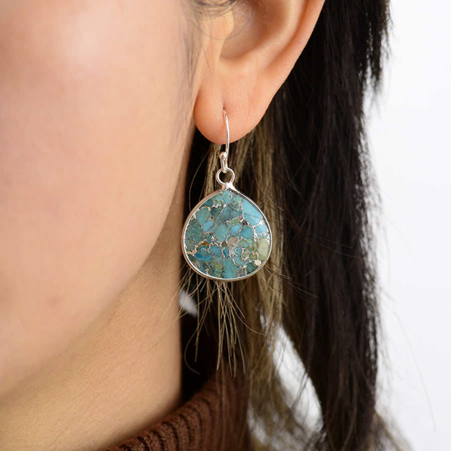 Turquoise matrix teardrop earrings with silver setting.