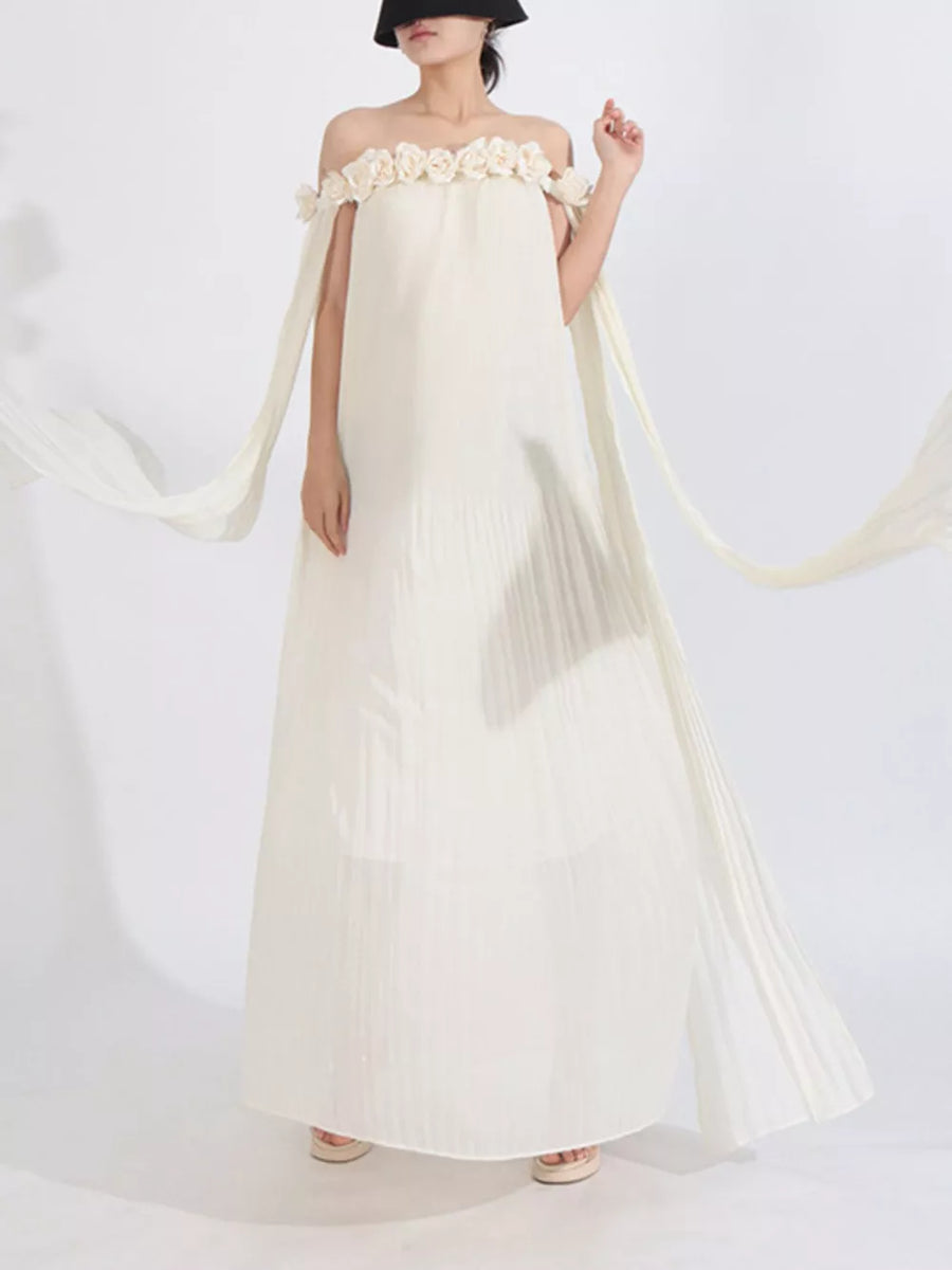 Elegant off-shoulder maxi dress in cream with floral appliques and flowing cape sleeves.